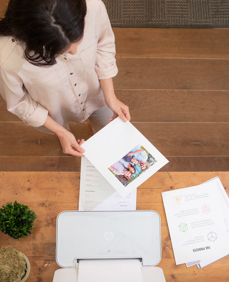 a woman analyses her printed document