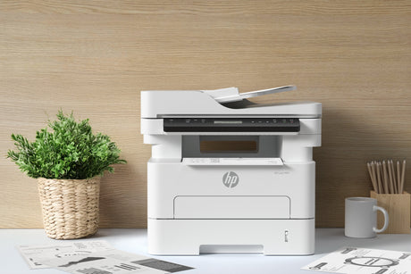 a printer and a plant in a clean home office setting