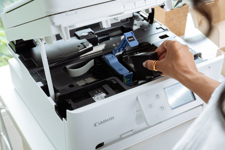 a woman replaces an ink cartridge