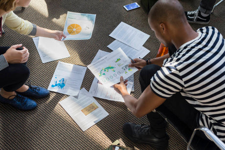 students look at their printed coursework