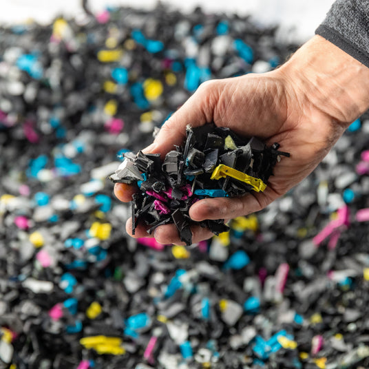a handful of broken pieces of recycled ink cartridges
