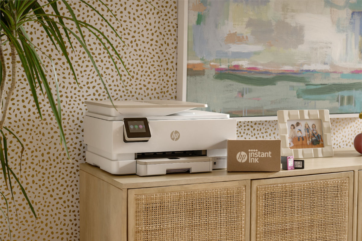 A HP Printer with a recently delivered box of hp instant ink alongside it