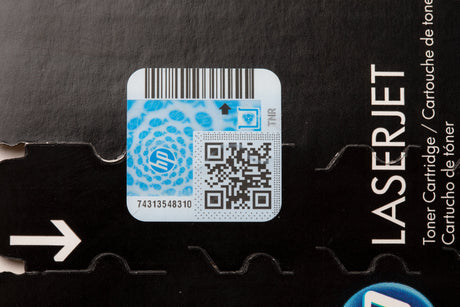 Close-up of HP's holographic anti-counterfeiting security label with QR code on a LaserJet toner box