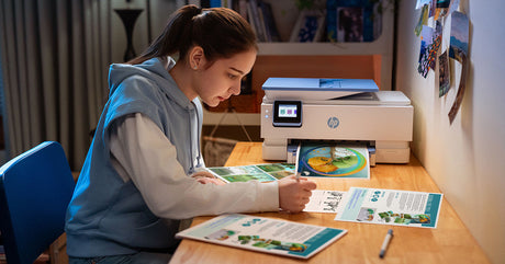 a girl works while her printer prints