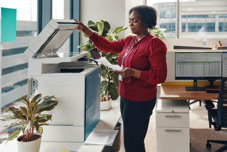 a lady prints documents at her printer