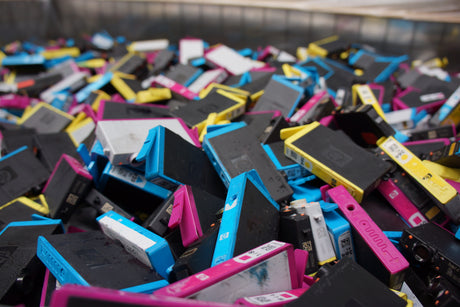 a mass of old empty ink cartridges ready for recycling