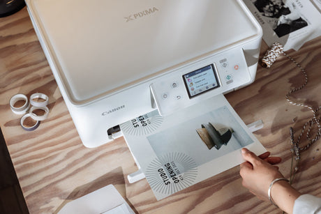 a woman prints some craft materials on her home printer