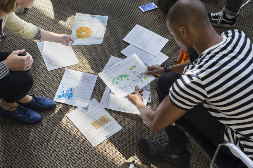 students look at their printed coursework
