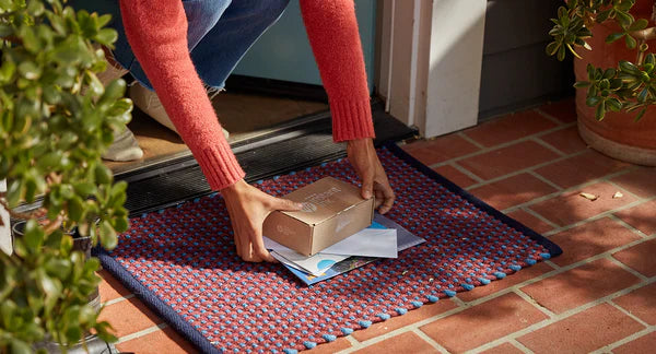 man collects his hp instant ink ink cartridge delivery from his doorstep