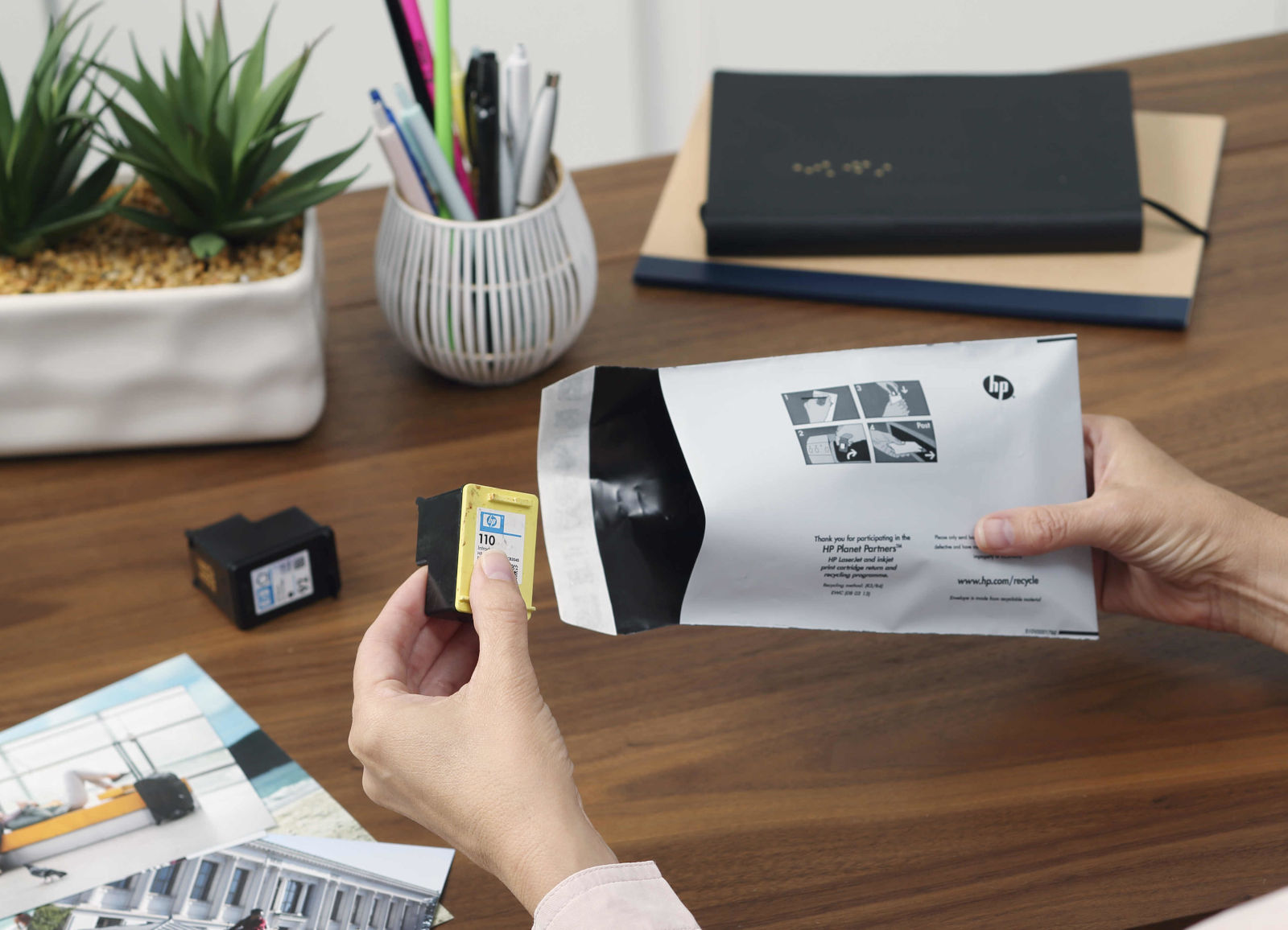 woman inserts her old empty ink cartridges into a free recycling envelope from crazy kangaroo