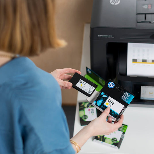 woman inspects her genuine ink cartridges