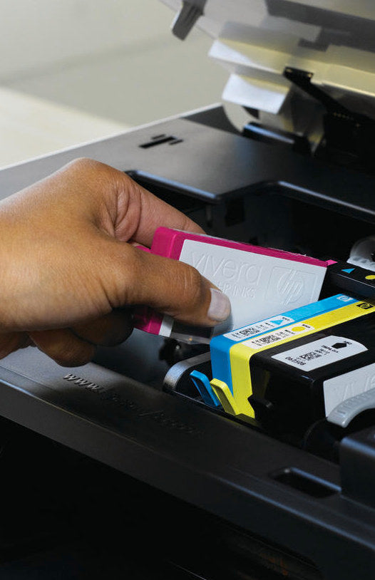 Woman loading an ink cartridge into her HP printer